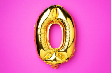 Creative layout. Golden foil balloon number and number zero 0. Birthday greeting card. Anniversary concept. Top view. Copy space. Stylish gold letter O over pink background. Digit zero.