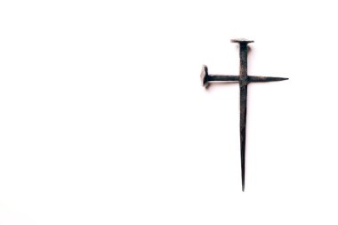 Cross made with rusty nails and drops of blood on white background. Copy space. Good Friday, Easter day. Christian backdrop. Biblical faith, gospel, salvation concept. Crucifixion of Jesus Christ.