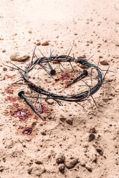 Good Friday, Passion of Jesus Christ. Crown of thorns and bloody nails on ground. Christian Easter holiday. Top view, copy space. Crucifixion, resurrection of Jesus Christ. Gospel, salvation.