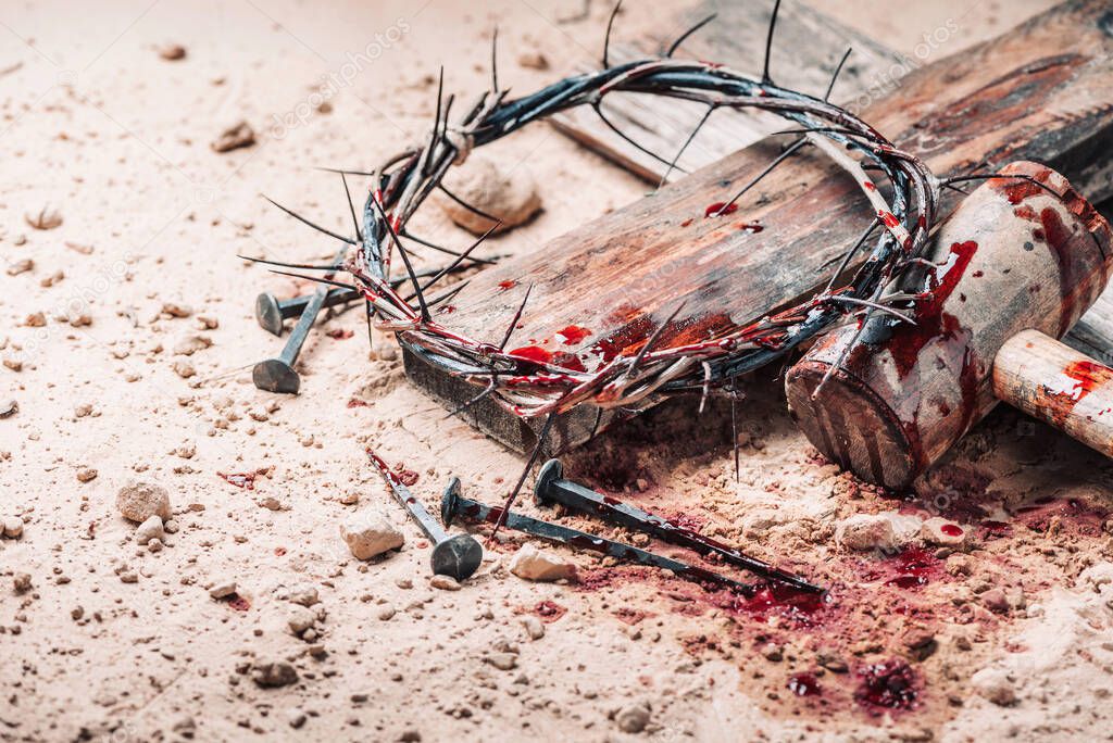 Old wooden cross, hammer, bloody nails and crown of thorns on ground. Banner. Copy space. Good friday. Passion, crucifixion of Jesus Christ. Christian Easter holiday. Gospel, salvation.