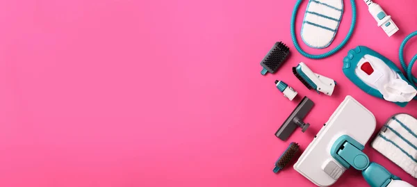 Kit of modern professional steam cleaners on pink background. Top view, flat lay. Banner with copy space. Cleaning service concept — Stock Photo, Image