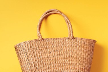 Son moda sarı arka planda kadınlar için saman torbası. Üst Manzara. Uzayı kopyala Yaz yolculuğu konsepti. Sürdürülebilir yaşam tarzı. Sıfır atık, plastiksiz konsept.