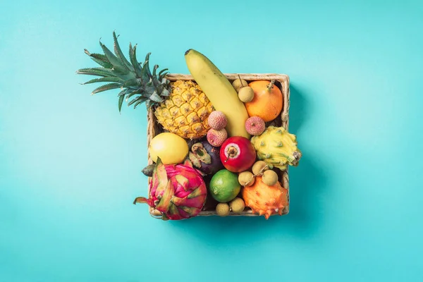 Caja de ratán llena de frutas exóticas de Tailandia: piña, pitahaya, kiwano, melón con cuernos africanos, fruta de tamarillo, granadilla, feijoa, salak, frutas de serpiente, maracuya, rambután, lichi, longan, tamarindo — Foto de Stock