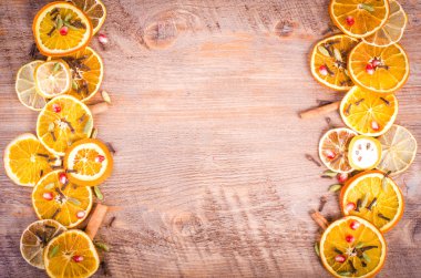 Slices of dried orange, lemon, cinnamon, cloves, cardamom. Christmas and New Year decoration frame. Free space for text.