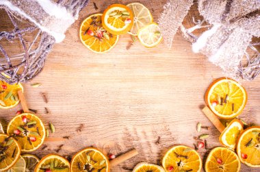 Slices of dried orange, lemon, cinnamon, cloves, cardamom. Christmas and New Year decoration frame. Free space for text.