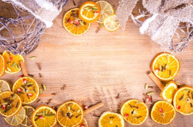 Slices of dried orange, lemon, cinnamon, cloves, cardamom. Christmas and New Year decoration frame. Free space for text.