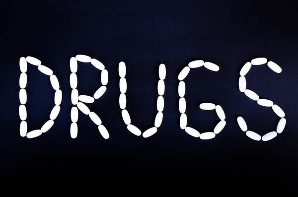 The word Prugs made with pills and drugs isolated — Stock Photo, Image