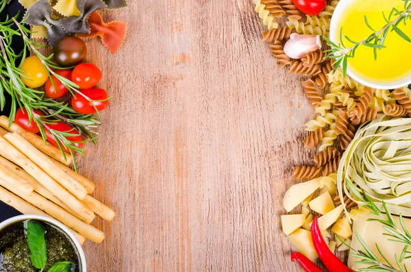 Ingridients for traditional italian dishes on wooden background. Free space for your text — Zdjęcie stockowe