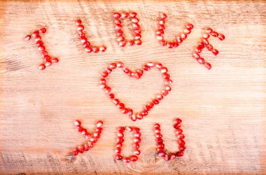 Red pomegranate letters, heart and text Love You