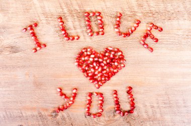 Red pomegranate letters, heart and text Love You