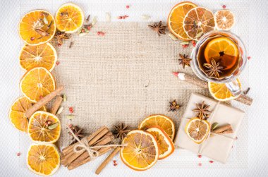 Dried oranges, cinnamon, cloves, cardamom, handmade milk chocolate with nuts, mulled wine, wooden pencil on sackcloth, canvas. Christmas, New Year and winter. Free space for your text.