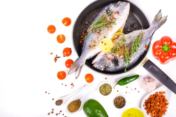 Fresh raw gilthead fishes with lemon, herbs, salt on white background. Healthy food concept. Food frame. Free space for your text. — Stockfoto