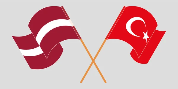 Banderas cruzadas y ondeando de Letonia y Turquía — Vector de stock