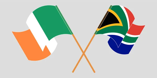 Banderas cruzadas y ondeantes de Irlanda y Sudáfrica — Archivo Imágenes Vectoriales