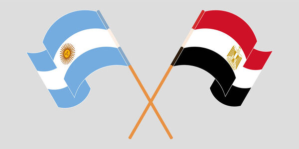 Crossed and waving flags of Egypt and Argentina