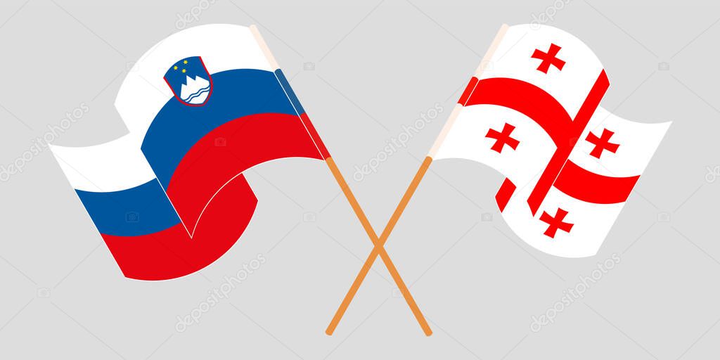 Crossed and waving flags of Georgia and Slovenia