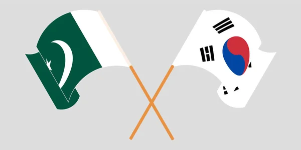 Bandeiras cruzadas e onduladas do Paquistão e da Coreia do Sul — Vetor de Stock