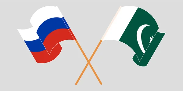 Gekruiste en wapperende vlaggen van Pakistan en Rusland — Stockvector