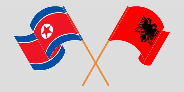 Bandeiras cruzadas e onduladas da Albânia e da Coreia do Norte — Vetor de Stock