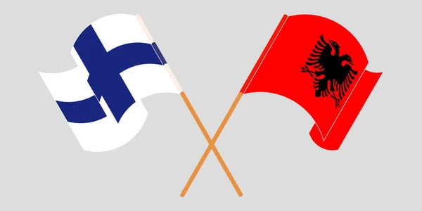 Bandeiras cruzadas e onduladas da Albânia e da Finlândia — Vetor de Stock