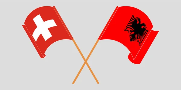 Bandeiras cruzadas e onduladas da Albânia e da Suíça — Vetor de Stock