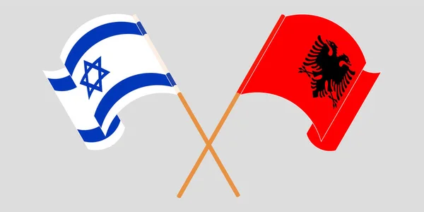 Bandeiras cruzadas e onduladas da Albânia e de Israel — Vetor de Stock