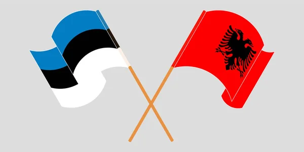 Bandeiras cruzadas e onduladas da Albânia e da Estónia — Vetor de Stock
