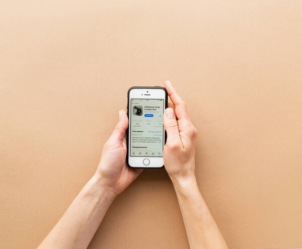 Belorechensk, Russia - March 1, 2021: Clubhouse application view on smartphone, female hands operating the clubhouse app