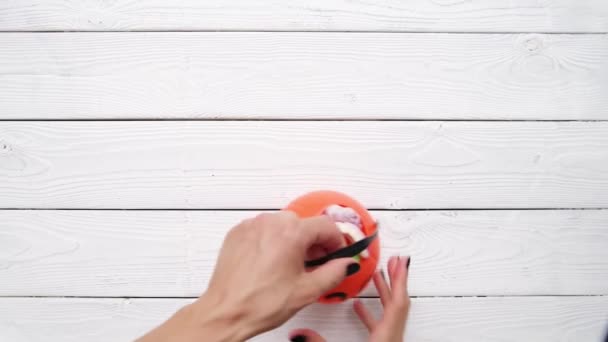 Concepto Halloween Manos Mujer Poniendo Dulces Calabaza Fondo Madera Blanca — Vídeos de Stock