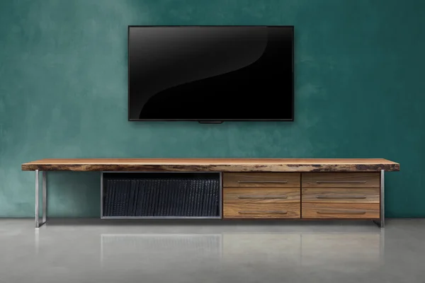 Tv on color concrete wall with wooden table interior vintage sty