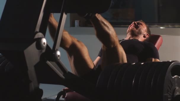 Hombre haciendo prensa de piernas en el gimnasio — Vídeo de stock