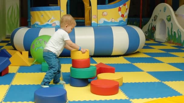 Little 2 year old toddler boy playing with pyramid — Stock Video