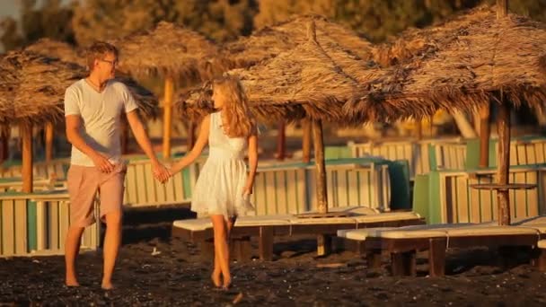 Молодая пара бежит вдоль побережья Эгейского моря — стоковое видео