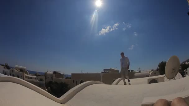 Elegant gentle groom walking on the roof — Stock Video