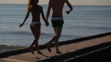 mutlu çift güneş doğarken kıyı çalışıyor