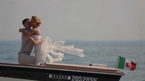 Поцелуи жениха и невесты на лодке — стоковое видео