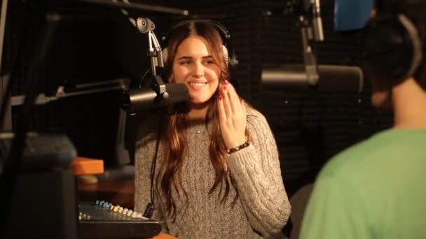 Attractive happy radio host interviewing a guest in studio — Stock Video