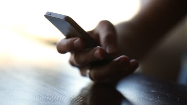 Close up hands uses phone in cafe