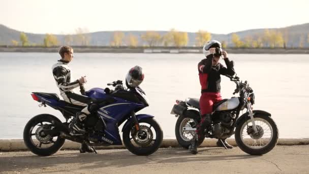 Junges Liebespaar vergnügt sich auf dem Motorrad am Wasser — Stockvideo