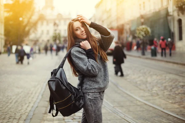 Street portrait of beautiful smiling young woman with backpack — Stock Photo, Image