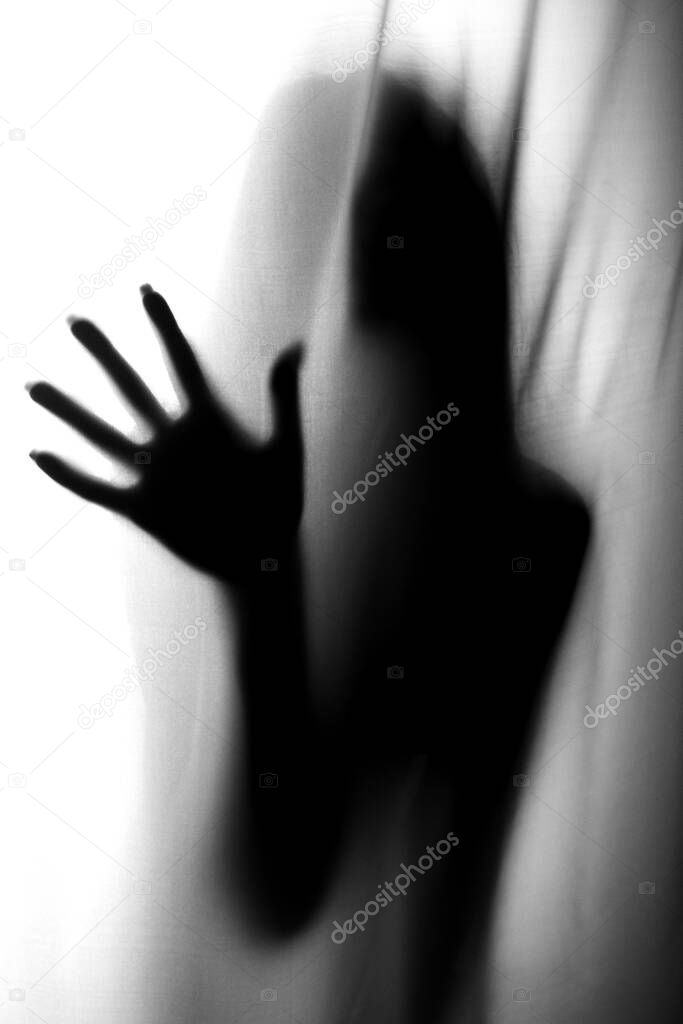 Silhouette of girl behind a curtain. Abstract and blurred image of a girl