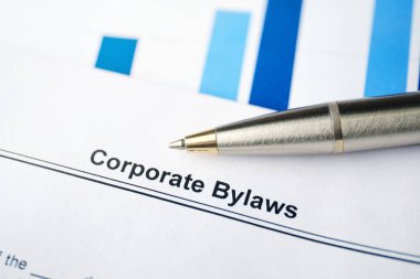 Legal document Corporate Bylaws on paper with pen. clipart