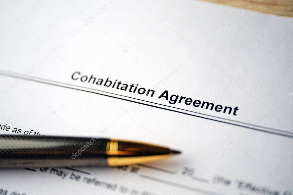 Legal document Cohabitation Agreement on paper with pen.