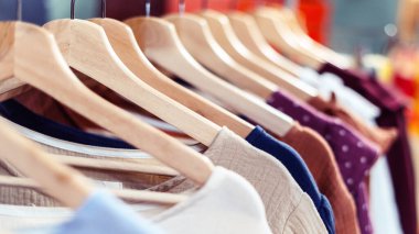 El yapımı yaz pamuğundan elbiseler mağazadaki askıda asılı.
