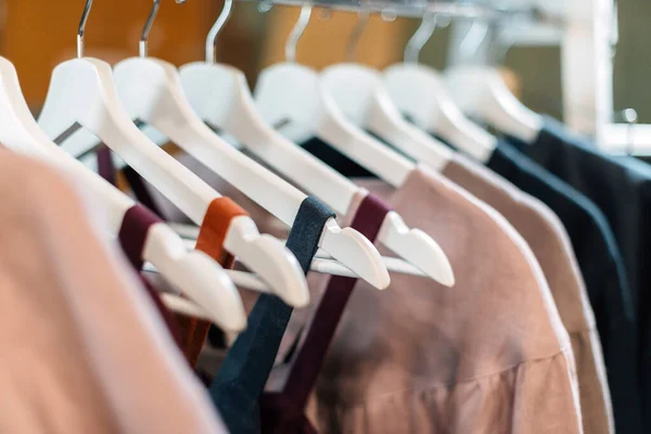 Light craft vintage linen dresses hanging on hangers in the store.