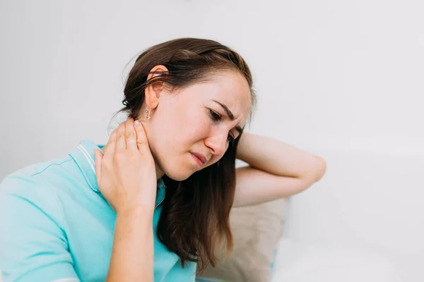 Woman thirties years old massages the neck from pinching the vertebrae. — Stock Photo, Image