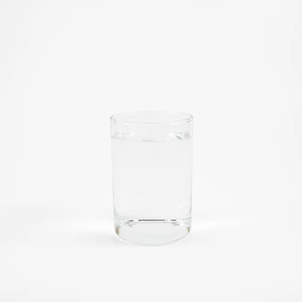 Średnich butli kieliszek czystej wody mineralnej — Zdjęcie stockowe