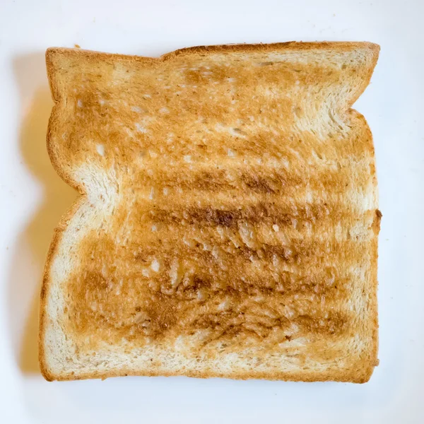 Torrada de pão saborosa em prato branco — Fotografia de Stock