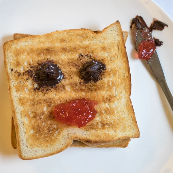 Tasty bread toast and strawberry jam with chocolate spread — Stock Photo, Image