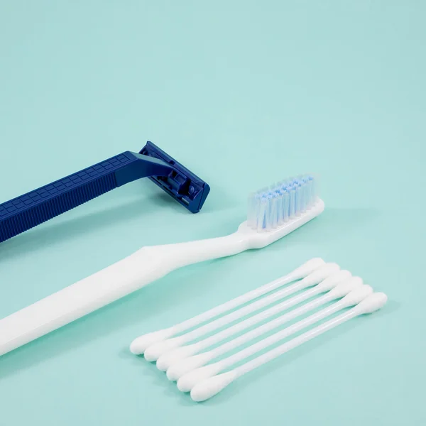 The white cotton buds with toothbrush and plastic razor. — Stock Photo, Image